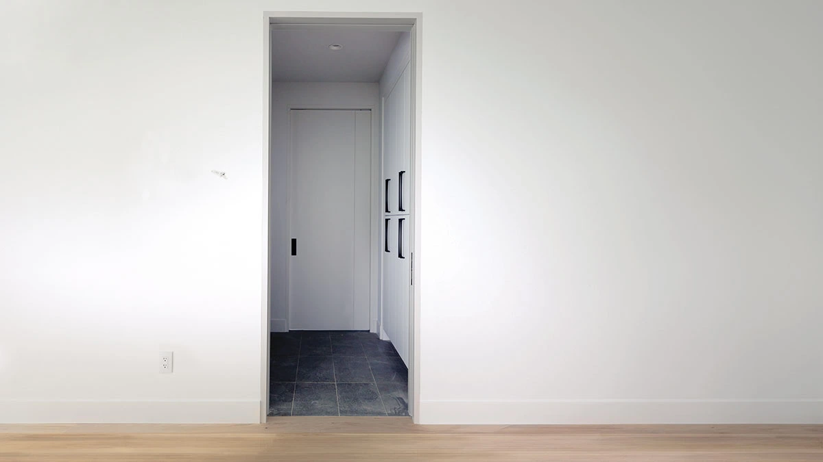 A sleek and modern pocket door saving space in a minimalist living room, blending functionality and style.